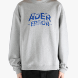 Grey sweater worn by a person, showing the sweater's fit