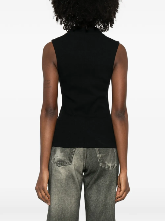 Black top worn by a person, showing the top fit