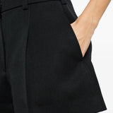 Close up of black shorts, showing texture of the wool fabric