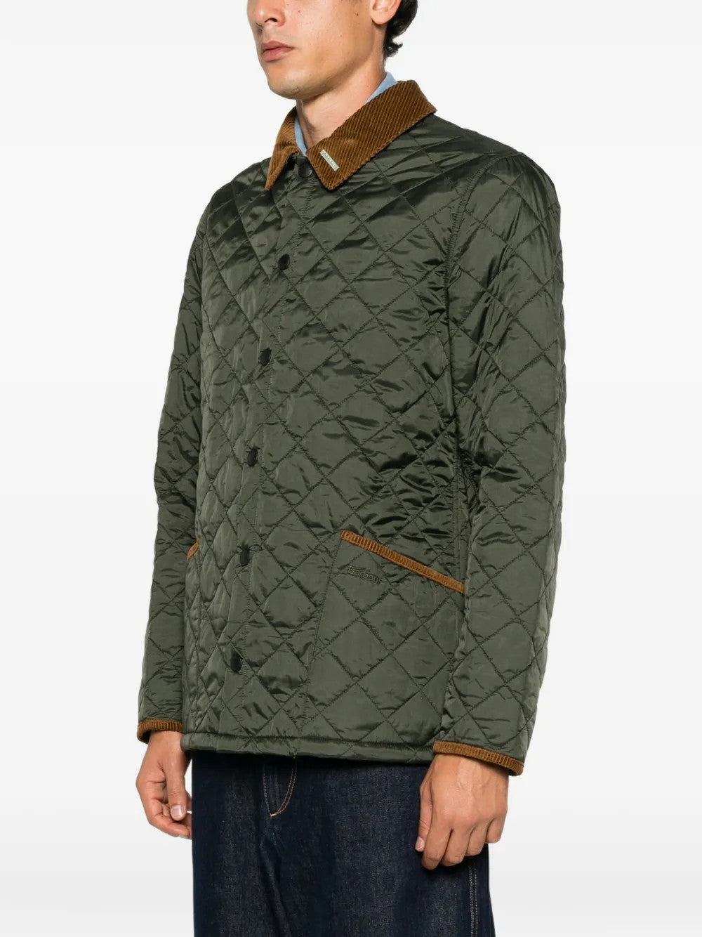 Green jacket worn by a person, showing the jacket fit
