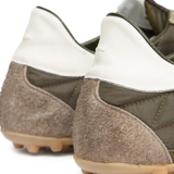 Close up of the grey sneakers, showing texture of the polyester and suede fabric