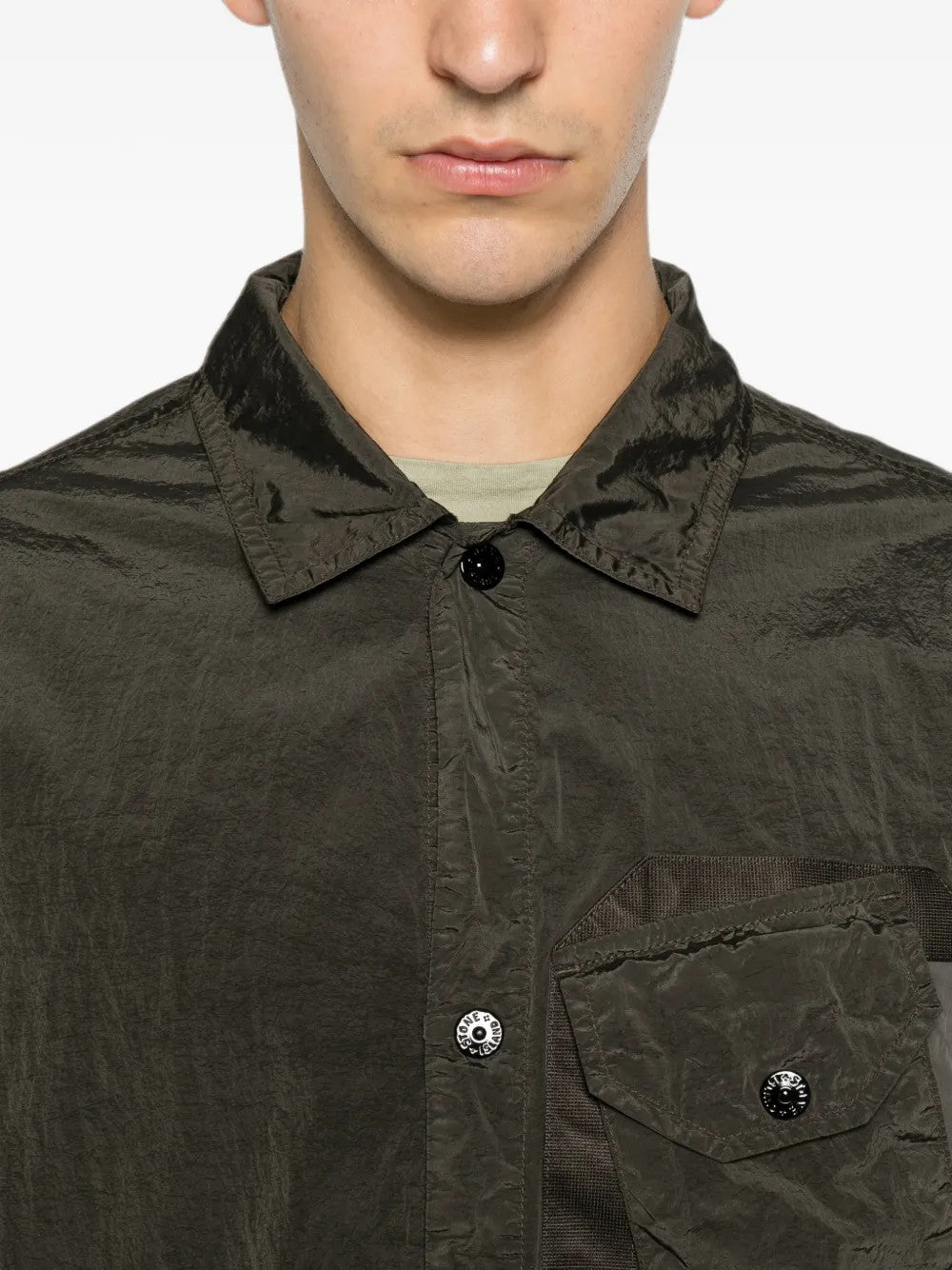 Green shirt worn by a person, showing the shirt fit