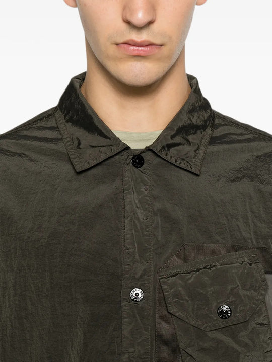 Green shirt worn by a person, showing the shirt fit