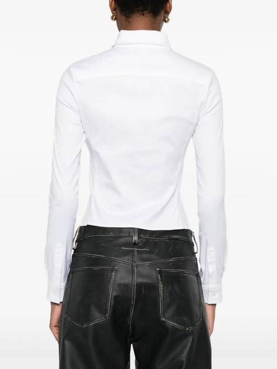 White shirt worn by a person, showing the shirt's fit