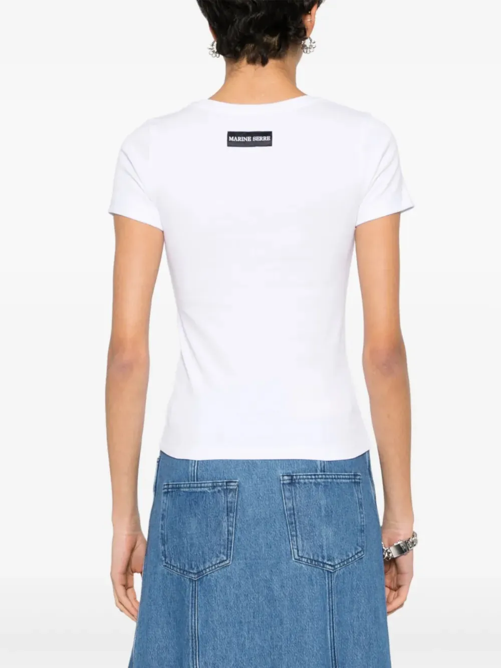 White t-shirt worn by a person, showing the t-shirt's fit