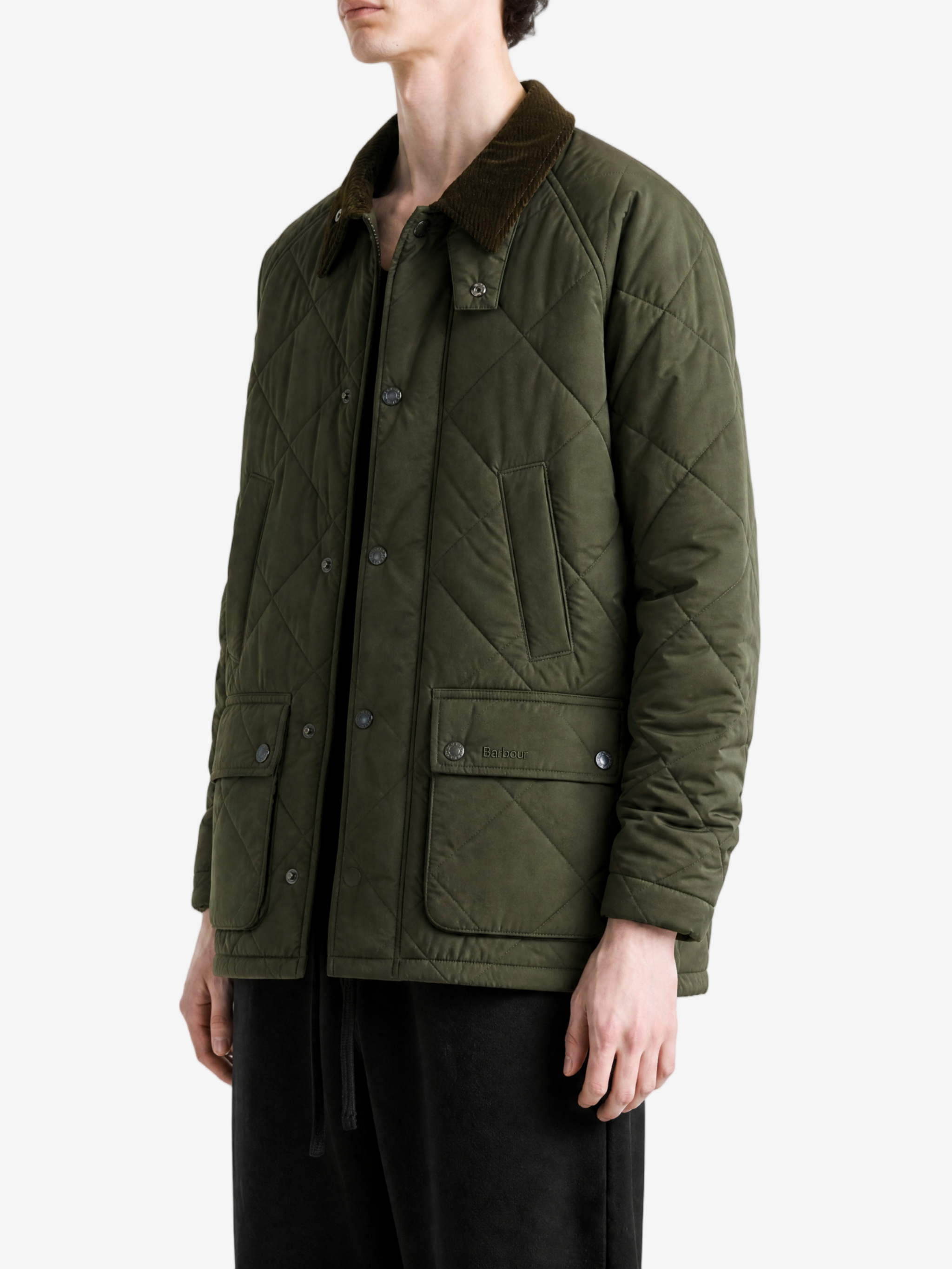 Green jacket worn by a person, showing the jacket fit