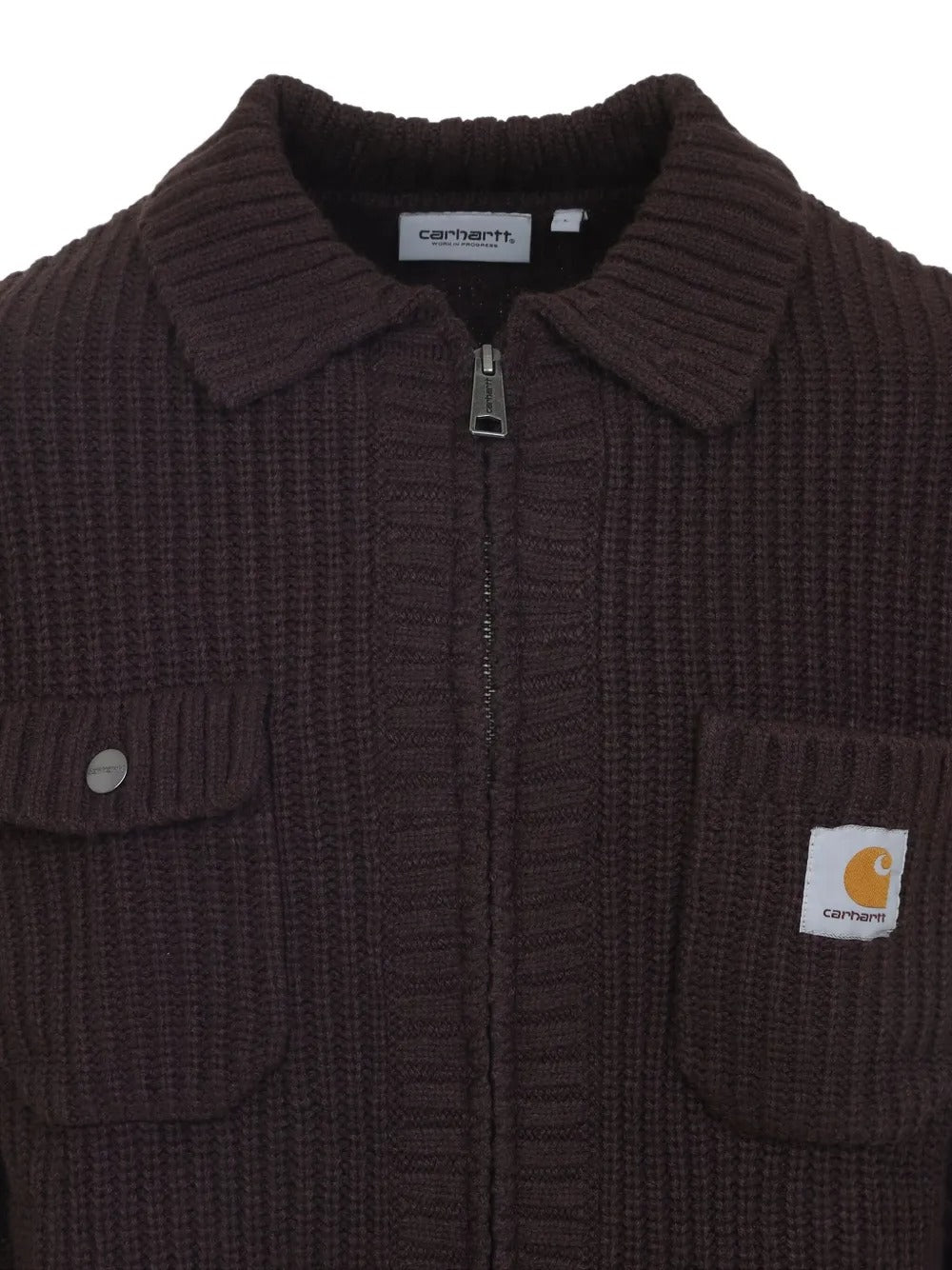 Close up of brown jackets, showing texture of the acrylic and wool and nylon fabric