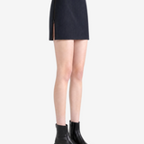 Black skirt worn by a person, showing the skirt fit