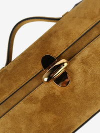 Close up of tan bag, showing the bag's lock