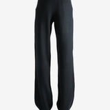 Black pants worn by a person, showing the pants' fit