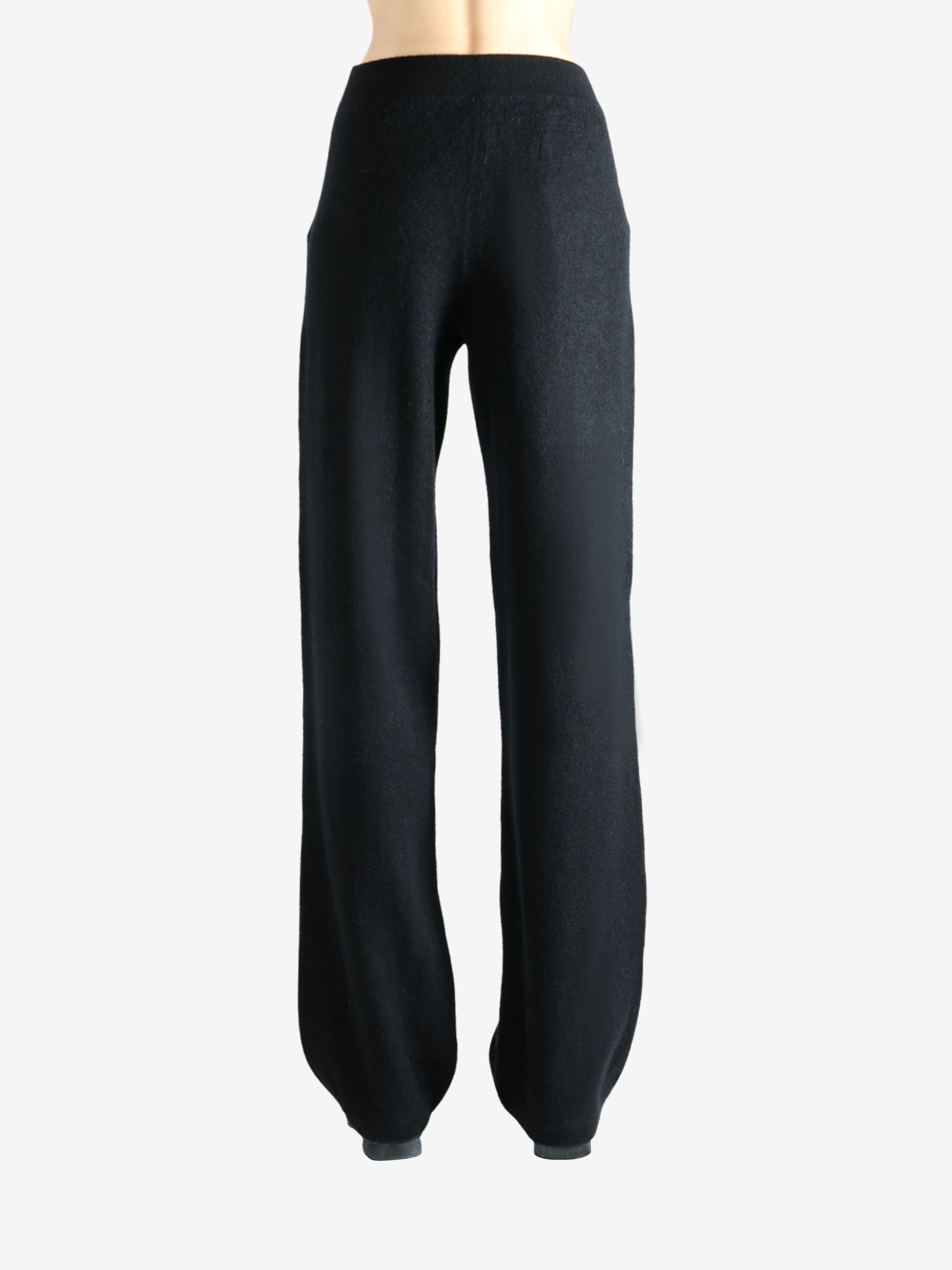 Black pants worn by a person, showing the pants' fit