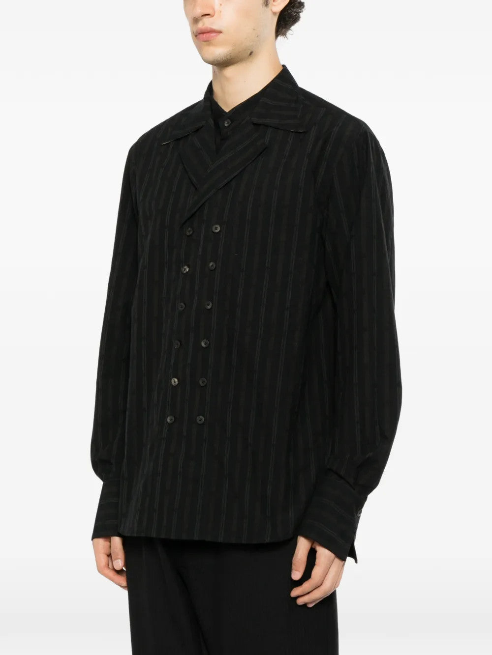 Black shirt worn by a person, showing the shirt fit