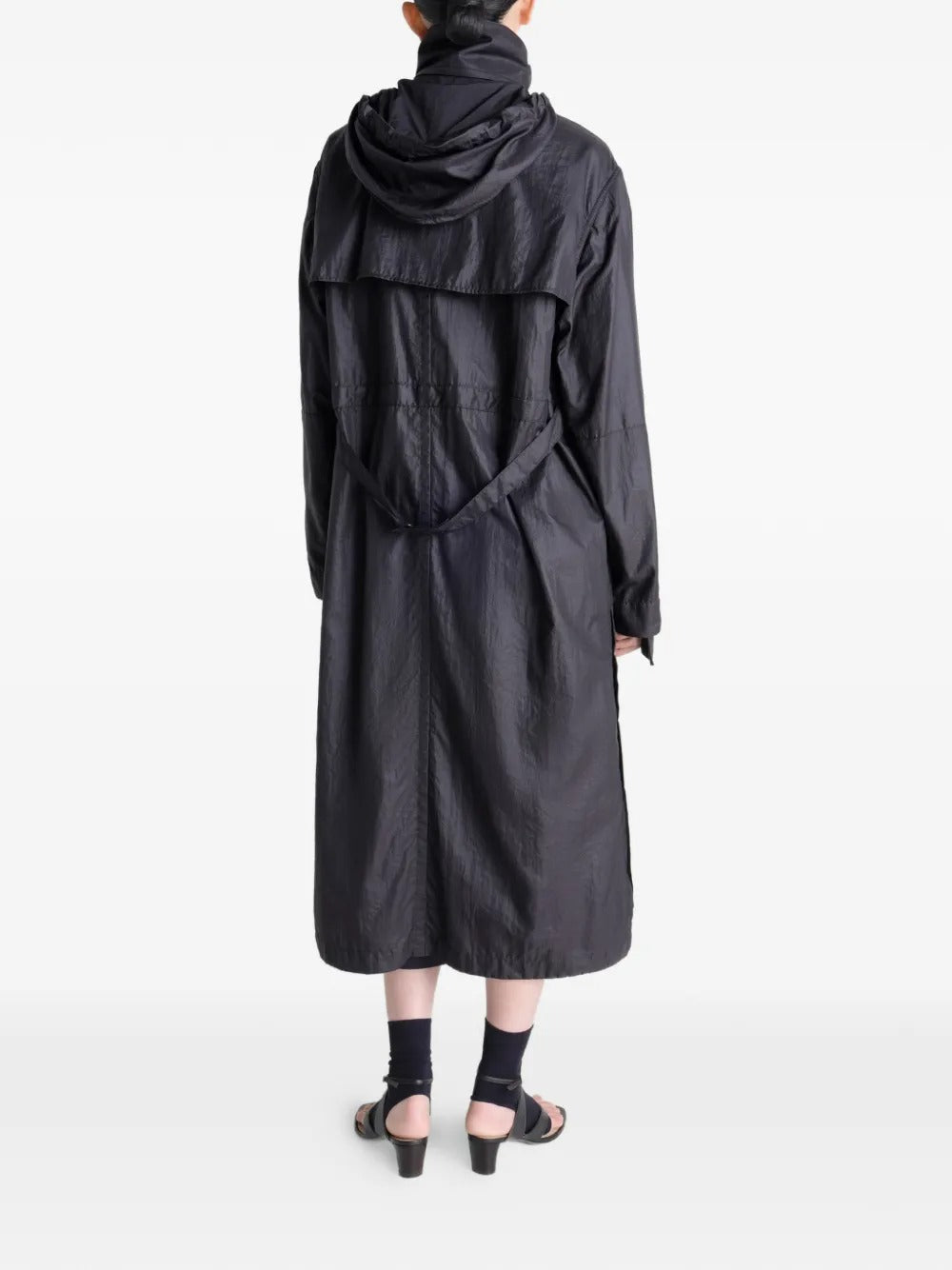 Black coat worn by a person, showing the coat's fit