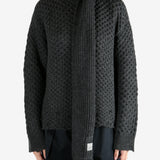 Grey knitwear worn by a person, showing the knitwear fit