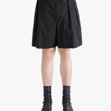 Black short worn by a person, showing the short's fit