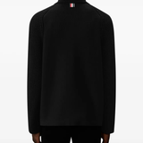 Black jacket worn by a person, showing the jacket fit