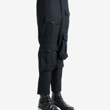 Black pants worn by a person, showing the pants fit