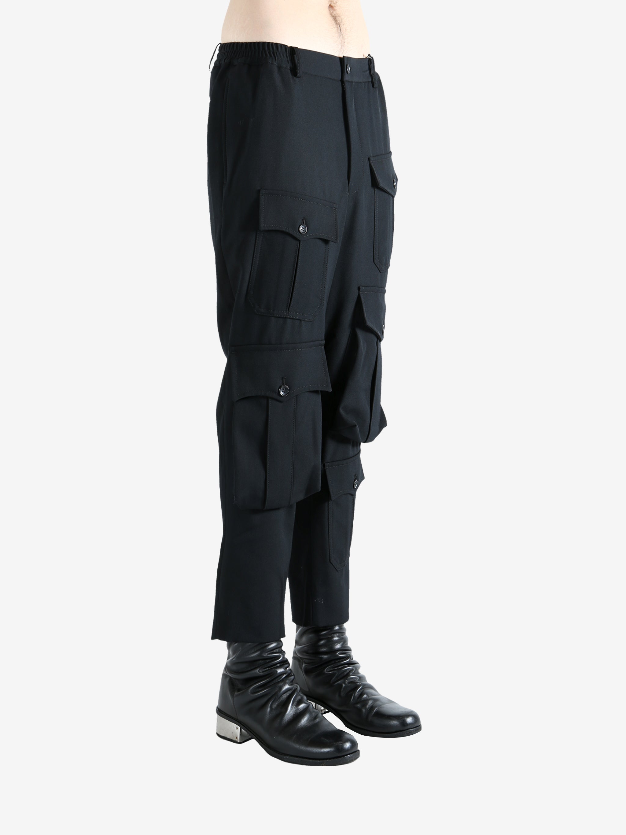 Black pants worn by a person, showing the pants fit