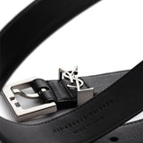 Close up of the black belt, showing texture of the leather fabric