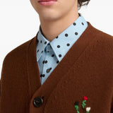 Brown knitwear worn by a person, showing the knitwear fit