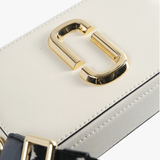Close up of the white bag, showing texture of the leather fabric