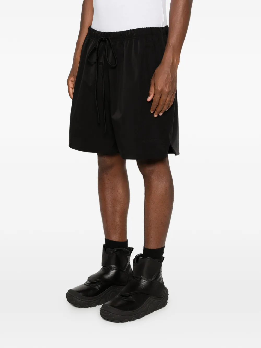 Black shorts worn by a person, showing the shorts fit