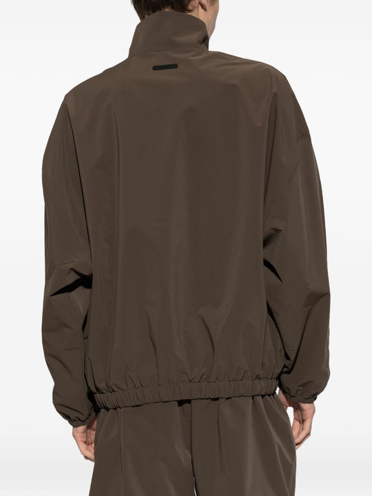 Brown jacket worn by a person, showing the jacket's fit