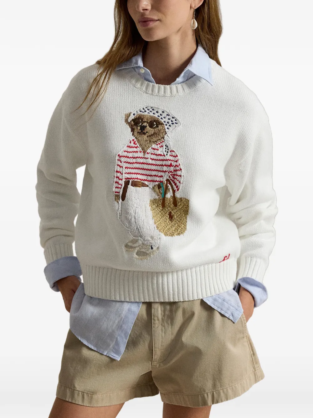 White knitwear worn by a person, showing the knitwear's fit