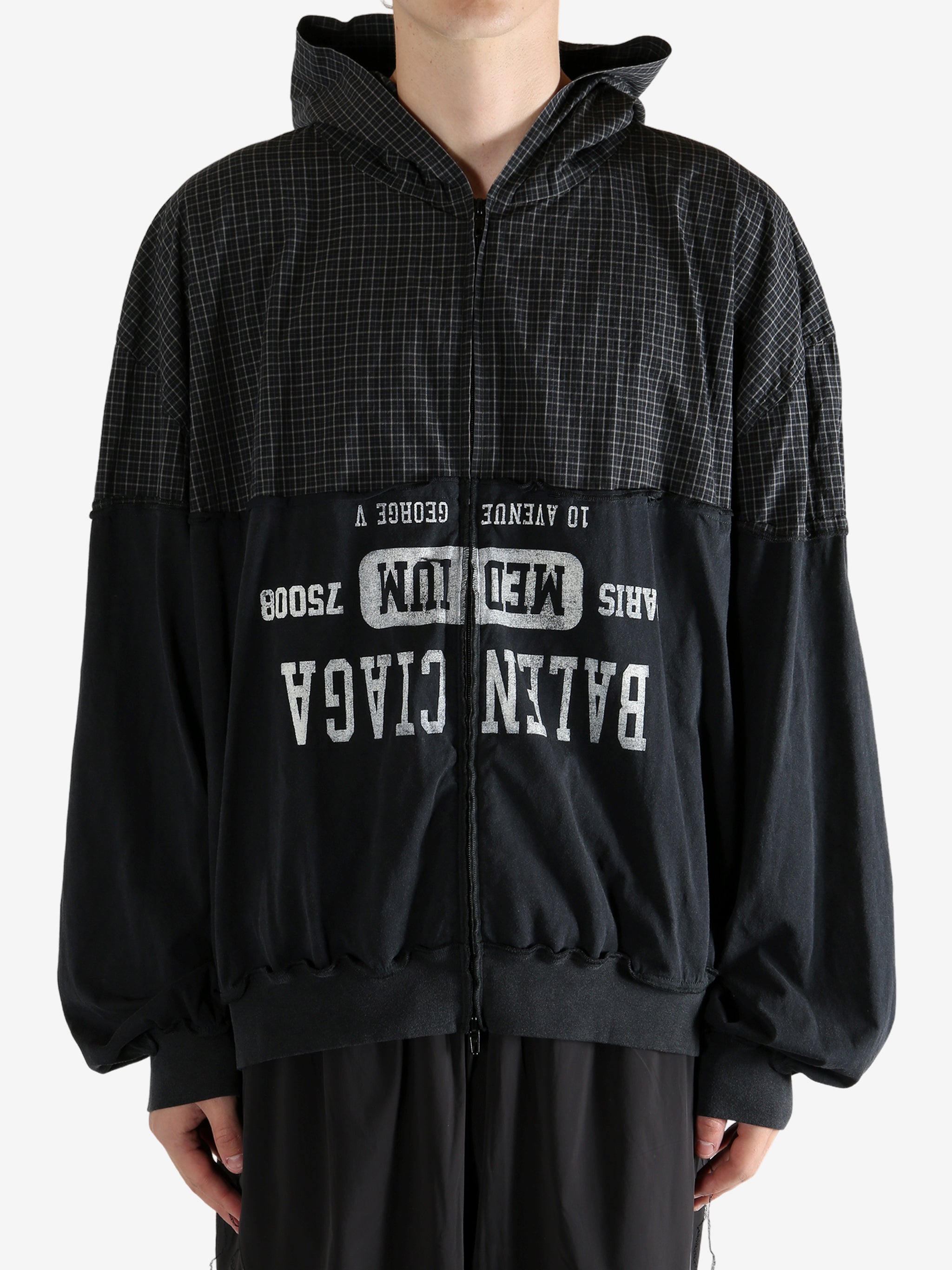 Black sweater worn by a person, showing the sweater's fit