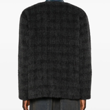 grey knitwear worn by a person, showing the knitwear fit