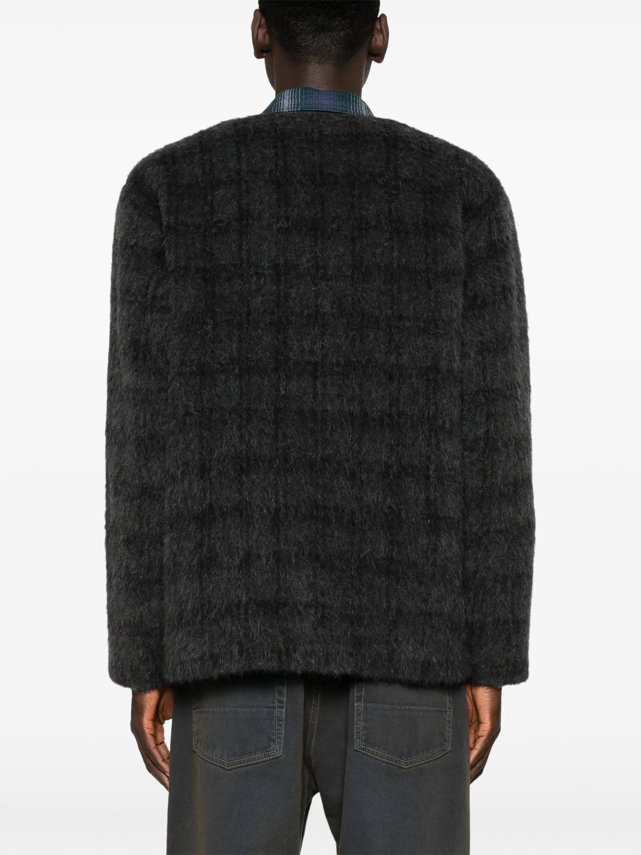 grey knitwear worn by a person, showing the knitwear fit