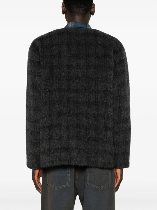 grey knitwear worn by a person, showing the knitwear fit