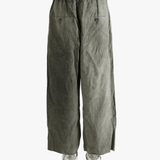 Green wide-leg pants worn by a person, showing the pants fit