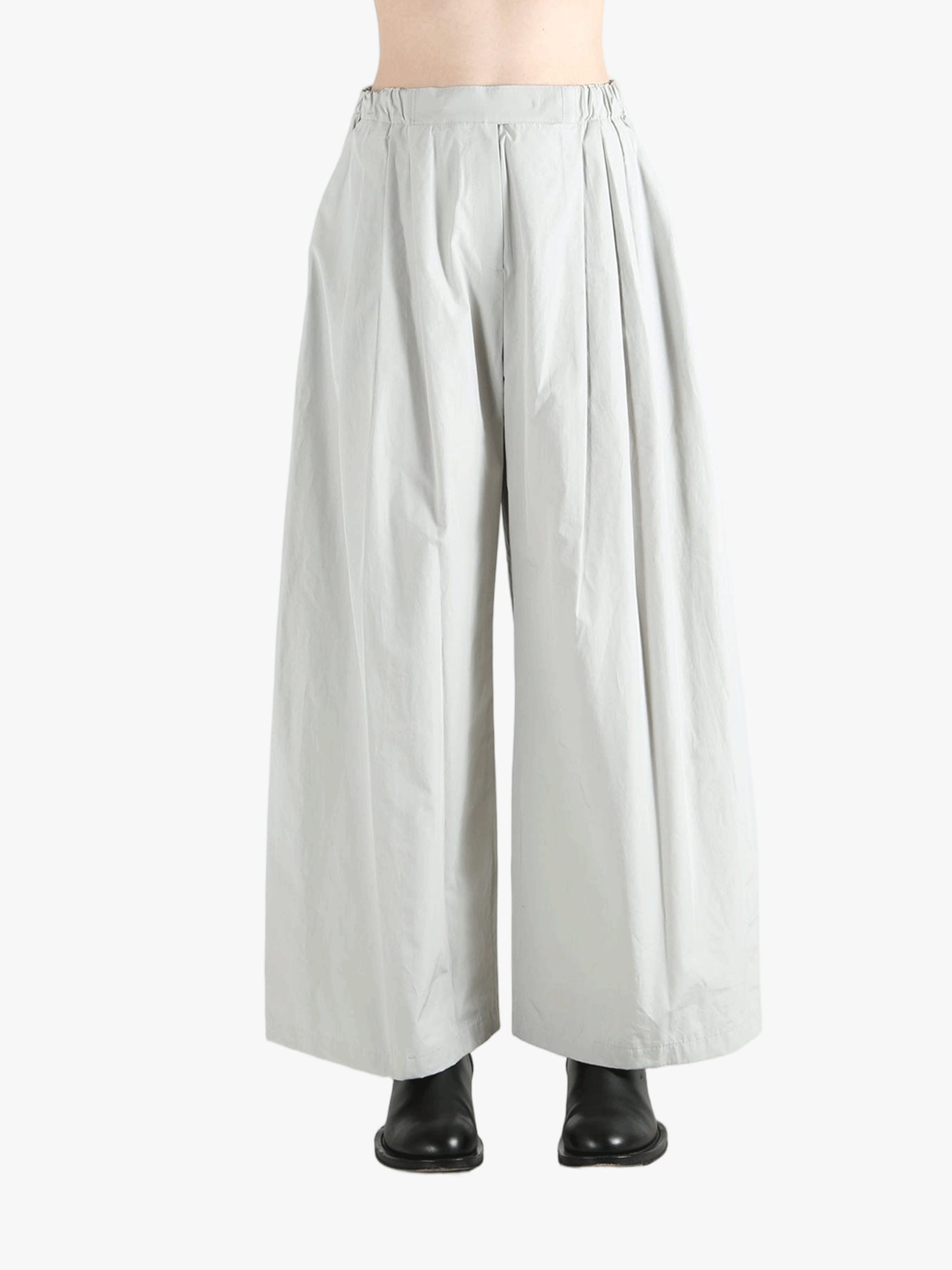 Grey pants worn by a person, showing the pants' fit