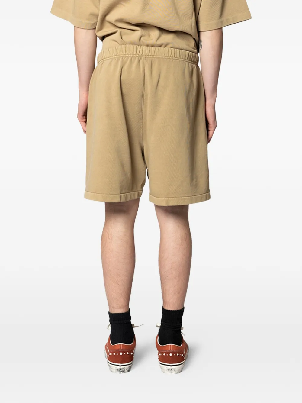 Tan shorts worn by a person, showing the shorts's fit