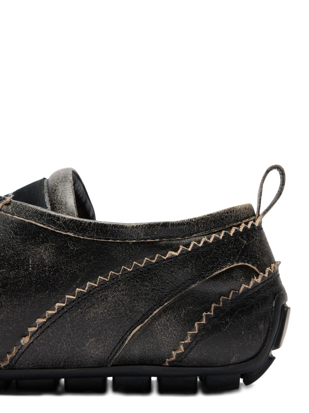 Close up of the brown shoes, showing texture of the leather fabric