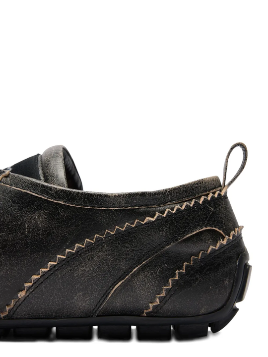 Close up of the brown shoes, showing texture of the leather fabric