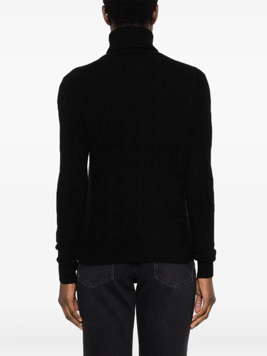 Black knitwear worn by a person, showing the knitwear fit