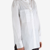 White shirt worn by a person, showing the shirt's fit