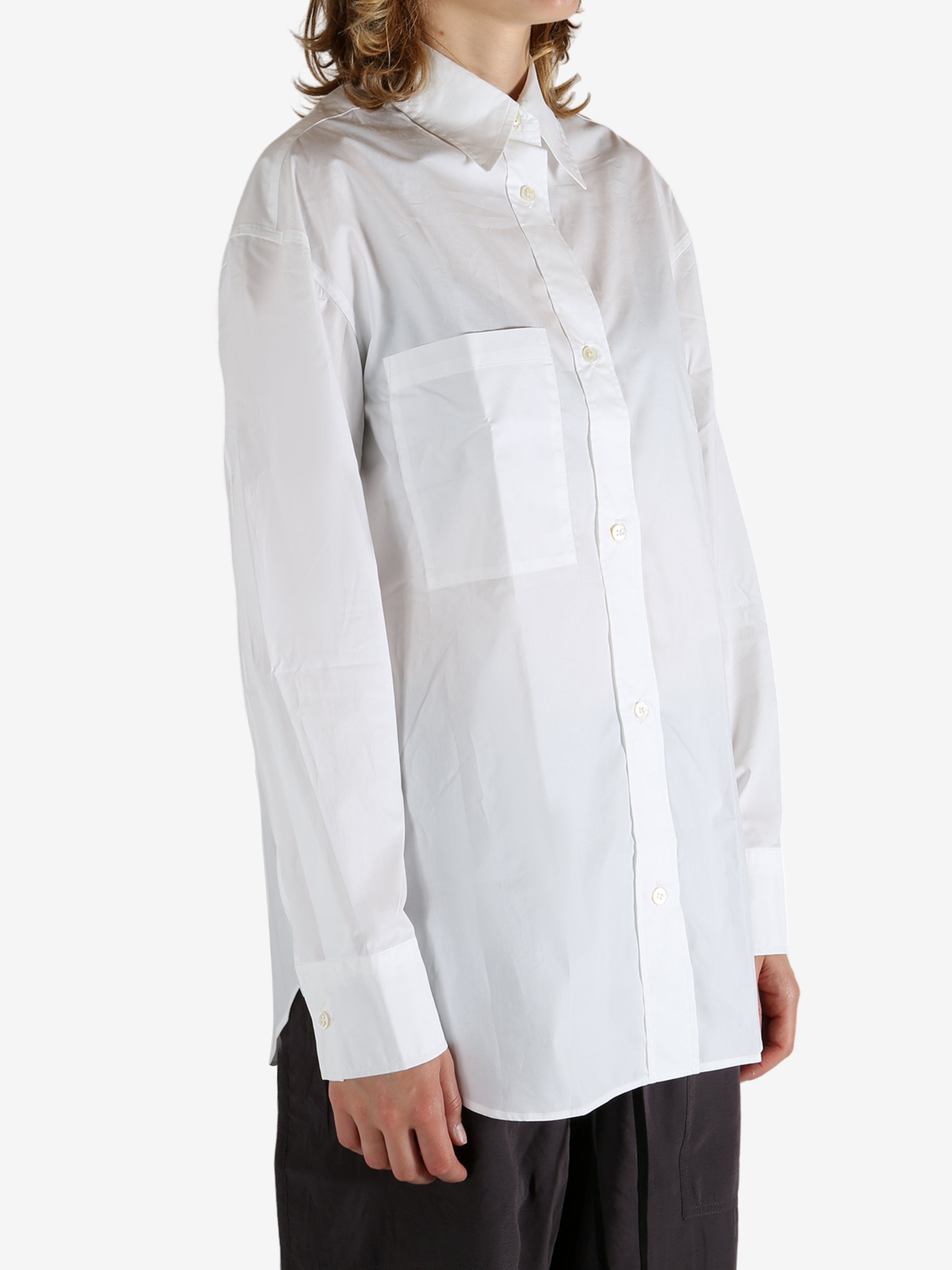 White shirt worn by a person, showing the shirt's fit