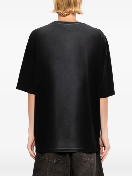 Black T-shirts worn by a person, showing the T-shirts' fit