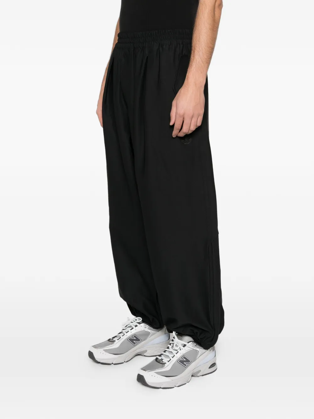 Black pants worn by a person, showing the pants fit