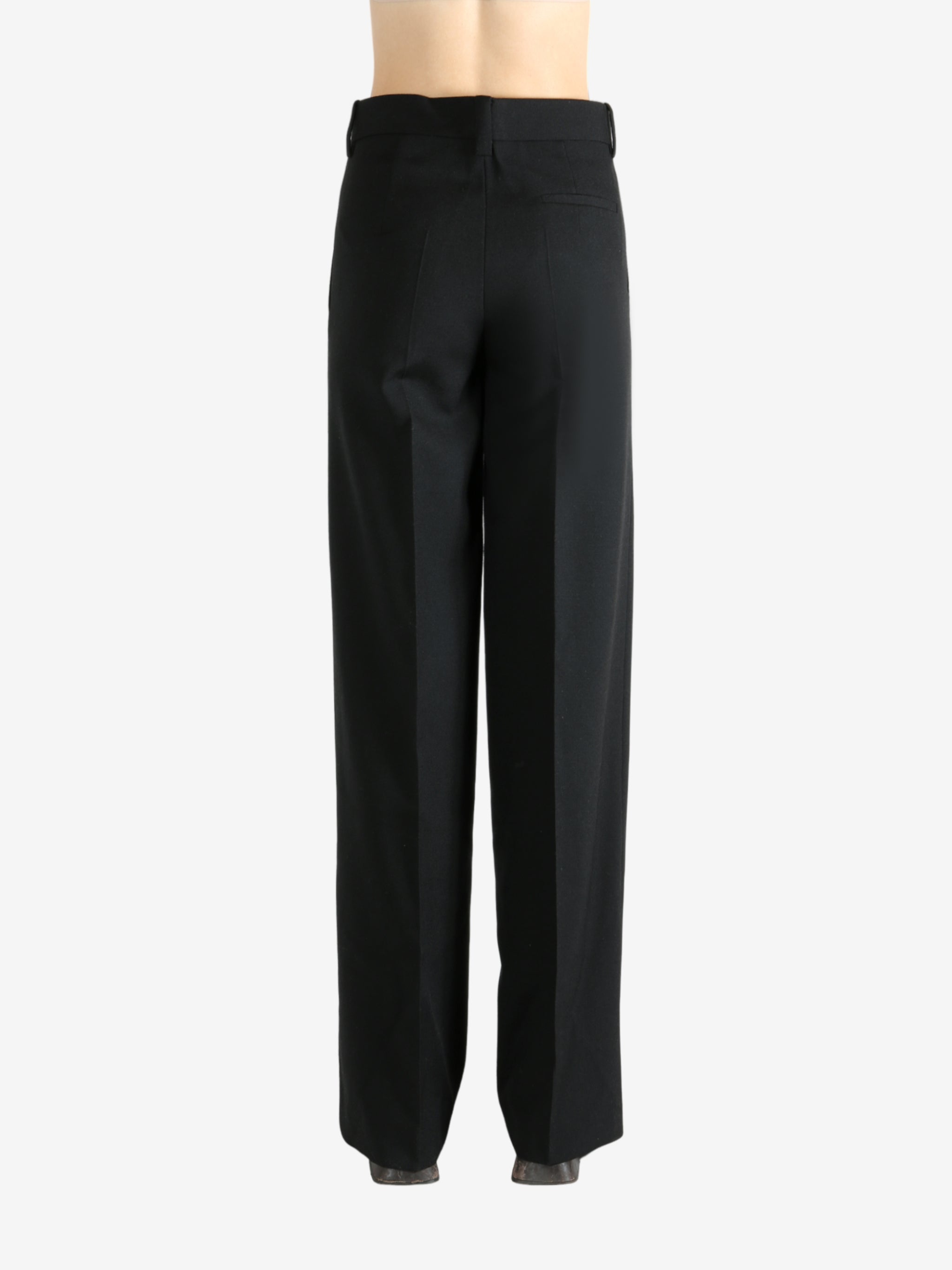 Black pants worn by a person, showing the pants' fit