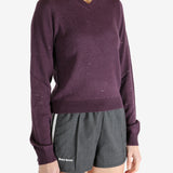 Purple knitwear worn by a person, showing the knitwear fit
