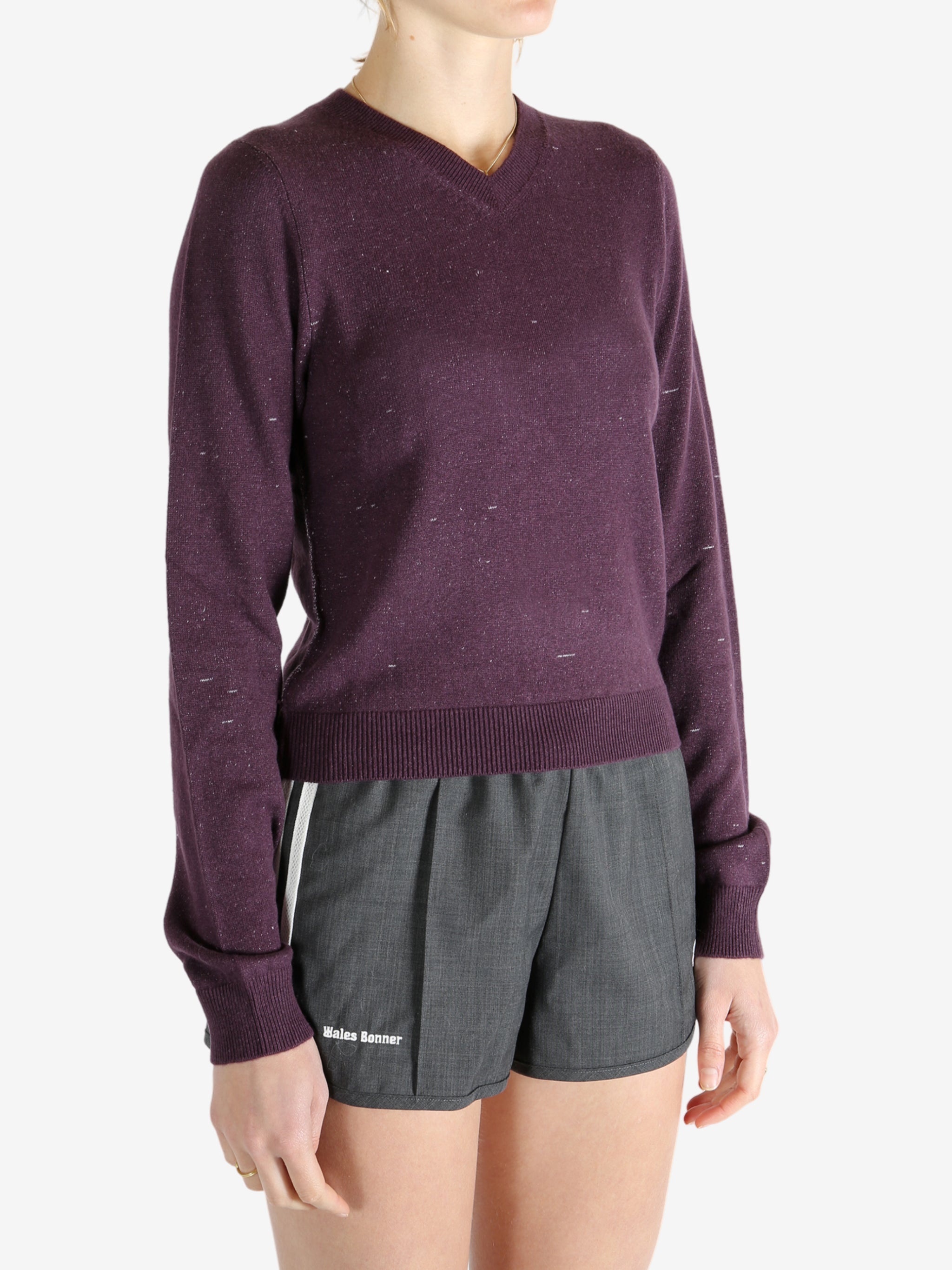 Purple knitwear worn by a person, showing the knitwear fit