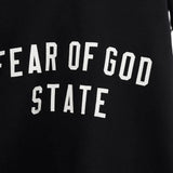 Close up of the black hoodie, showing texture of the cotton fabric