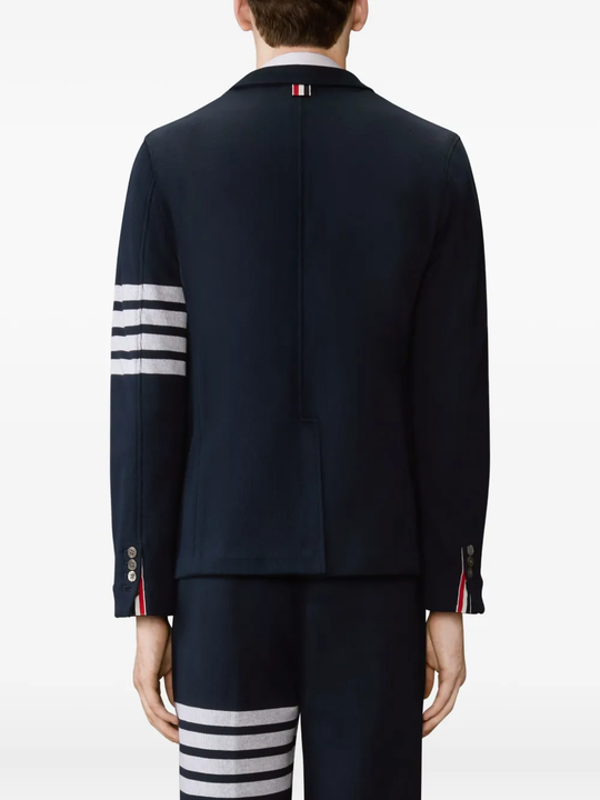 navy jacket worn by a person, showing the jacket fit