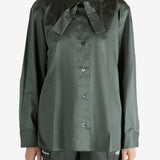 Green shirt worn by a person, showing the shirt's fit