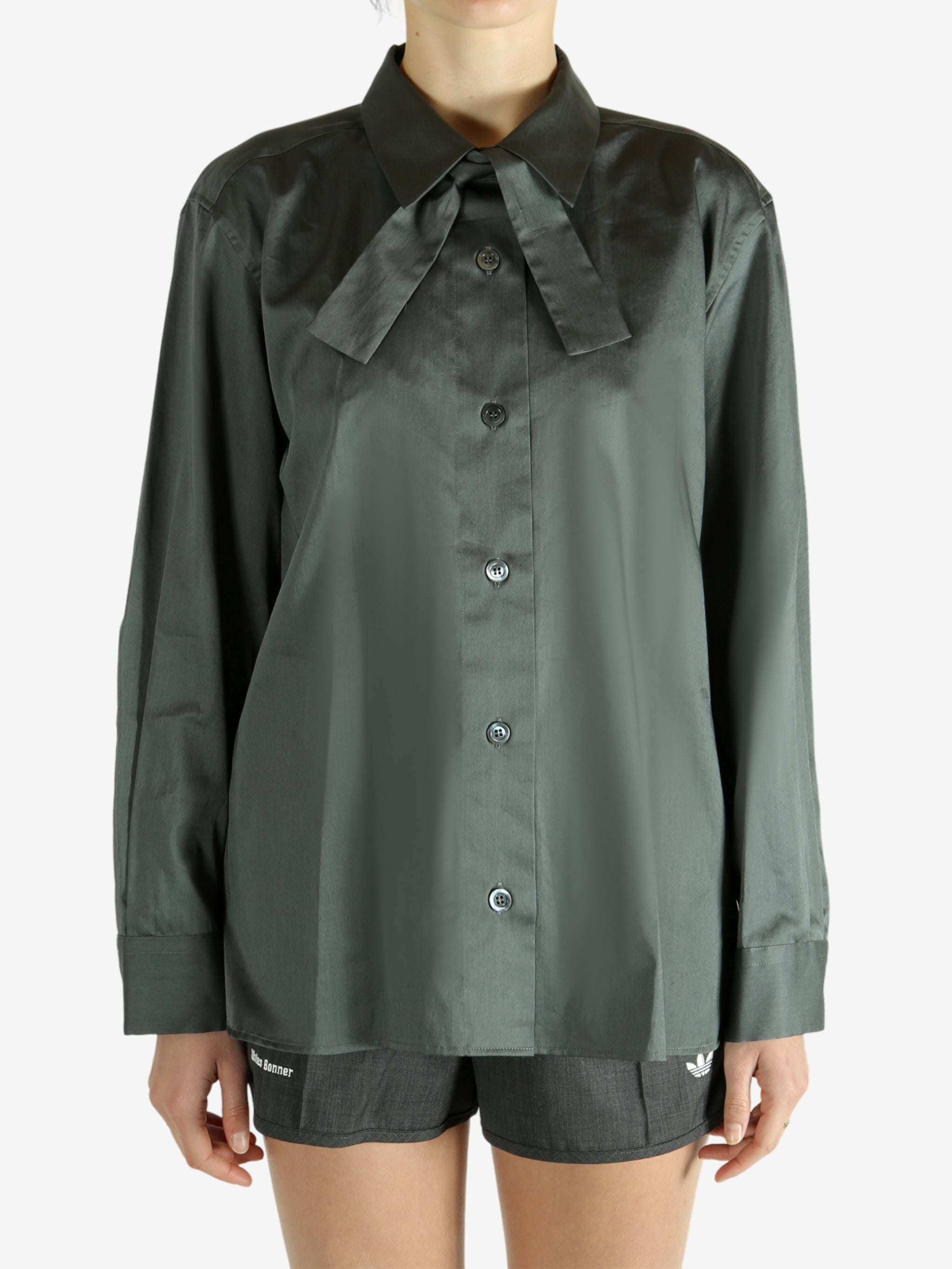 Green shirt worn by a person, showing the shirt's fit