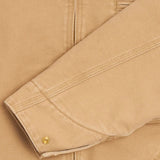 Close up of Tan jacket, showing texture of the 100% organic cotton made fabric
